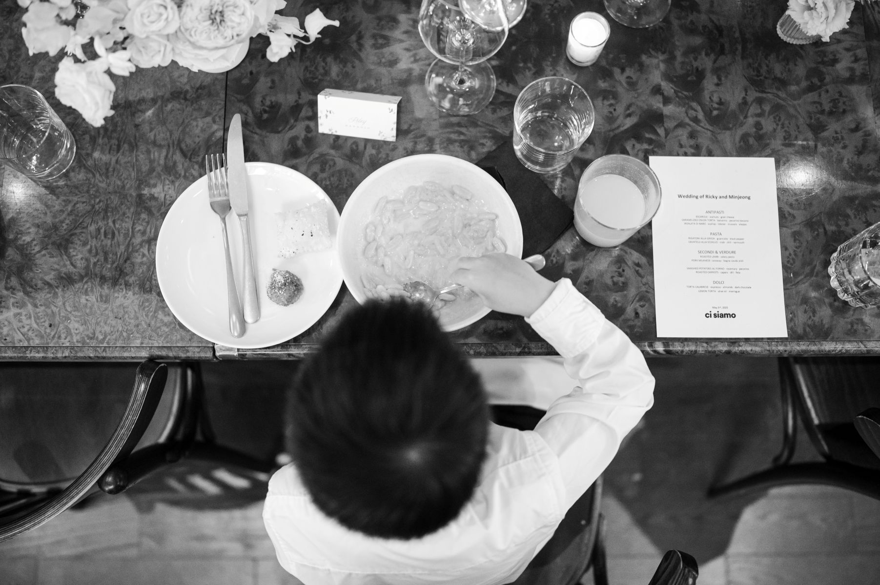 a young boy eating dinner at a wedding reception hosted at ci siamo in new york city 