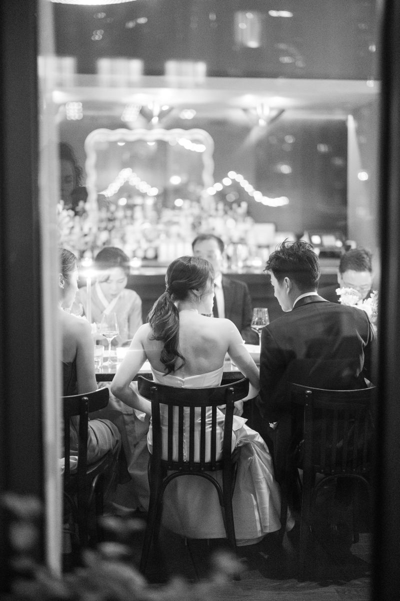 A group of people dressed formally sit around a table
