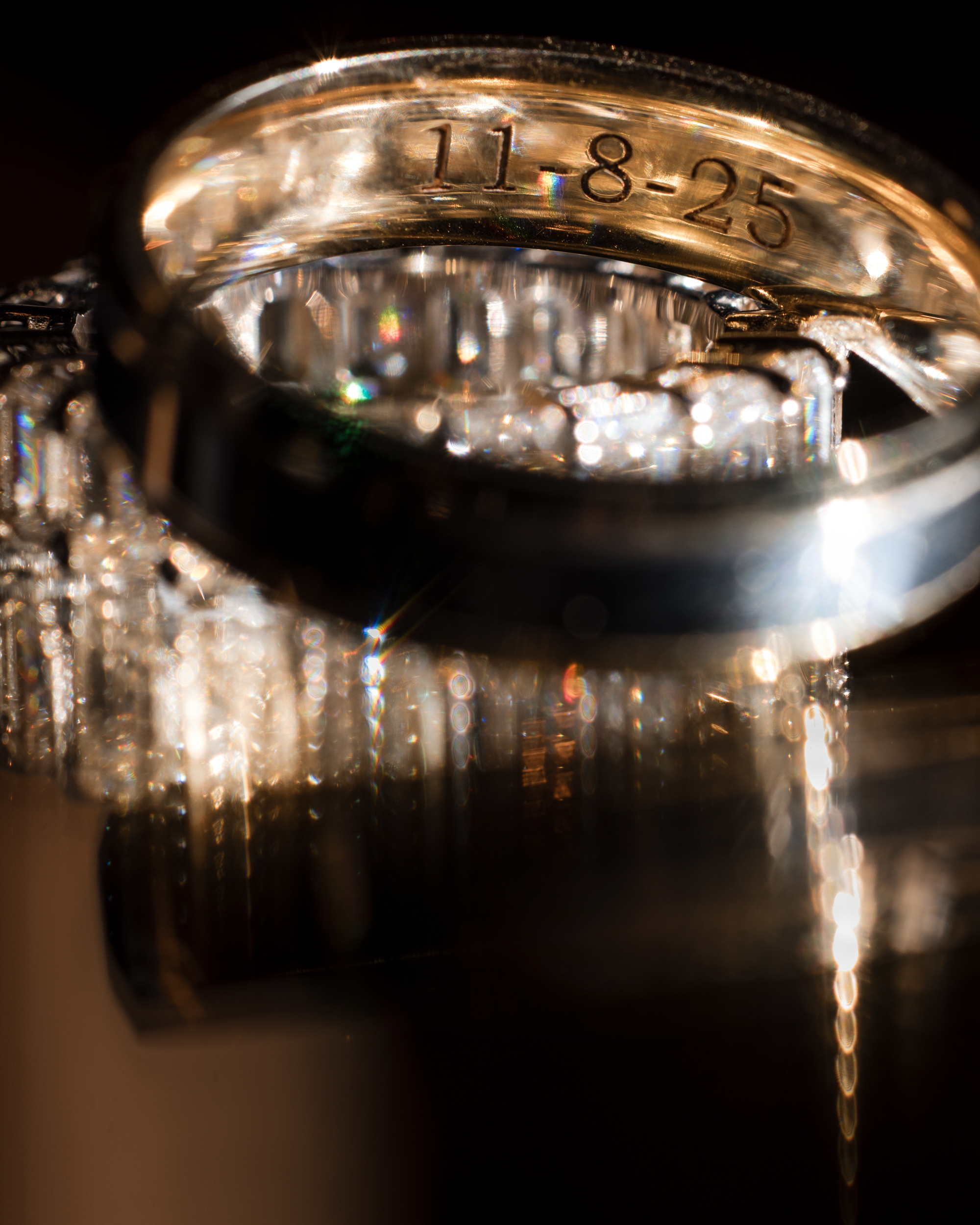 Close-up of a gold ring engraved with the date "11-8-25," its diamond details reflecting light—capturing memories from a beautiful Lake House Inn wedding.
