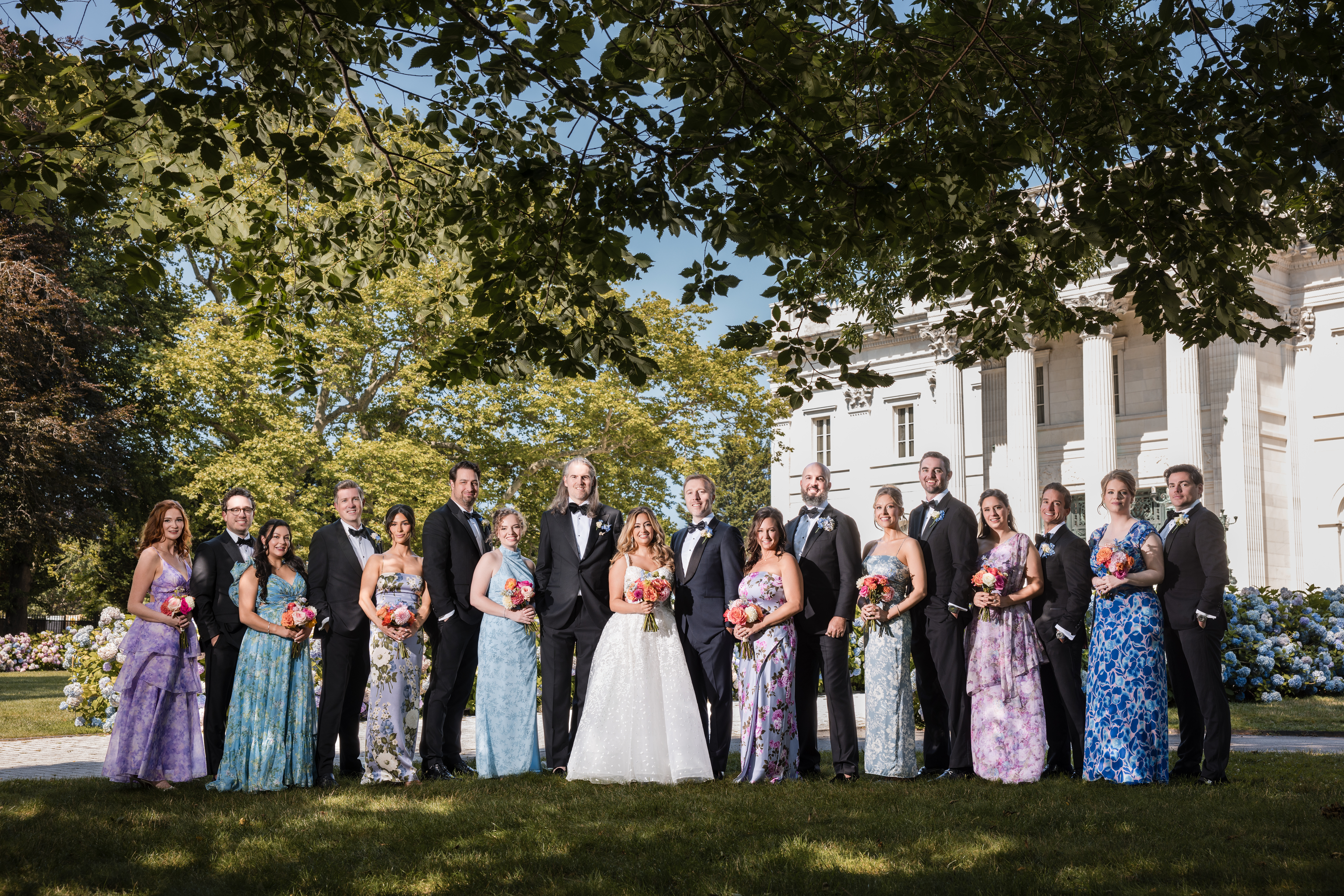 a wedding party poses for formal portraits at the Newport marble house before a Regatta Place wedding