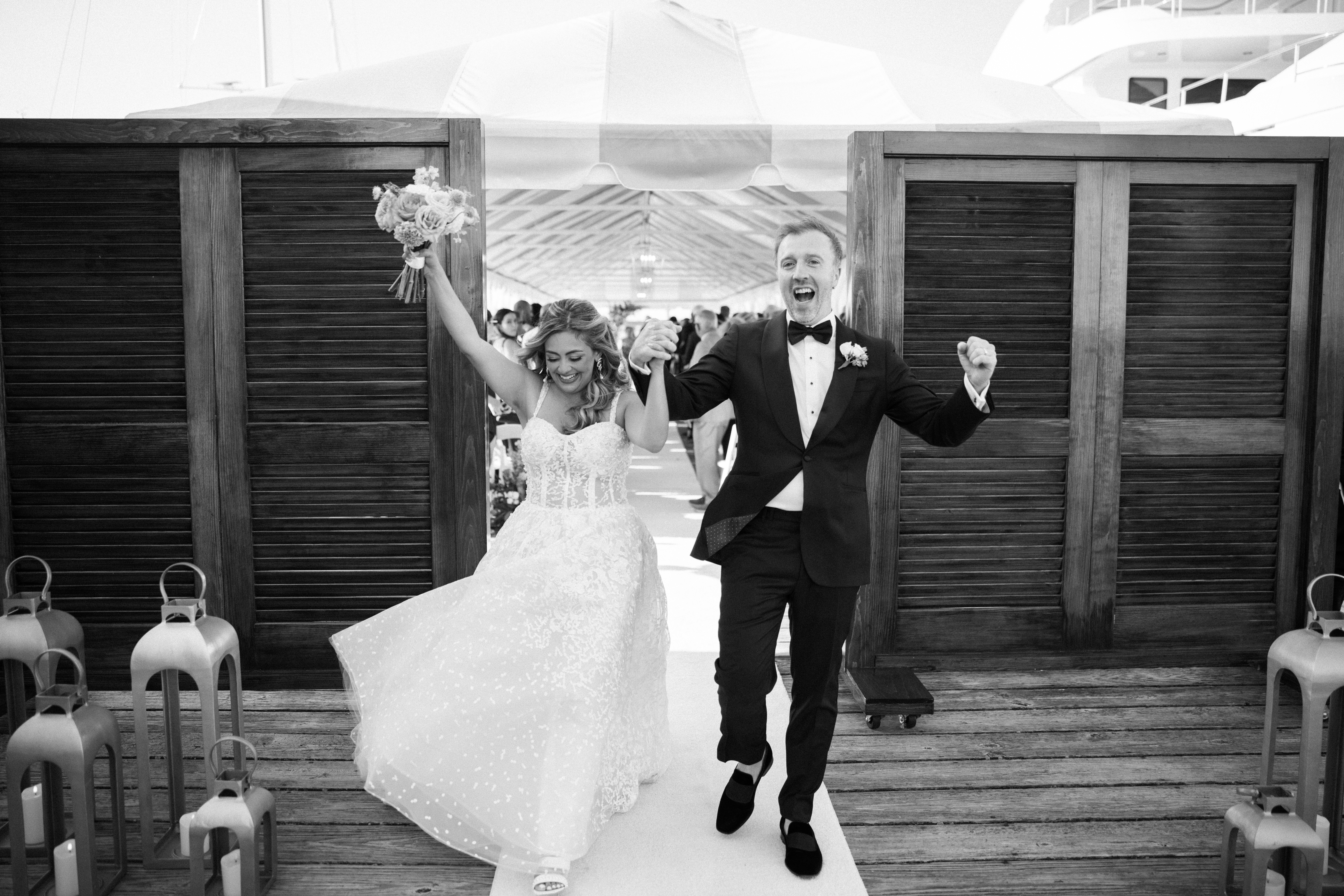 A bride and groom exit their dock wedding at Regatta Place