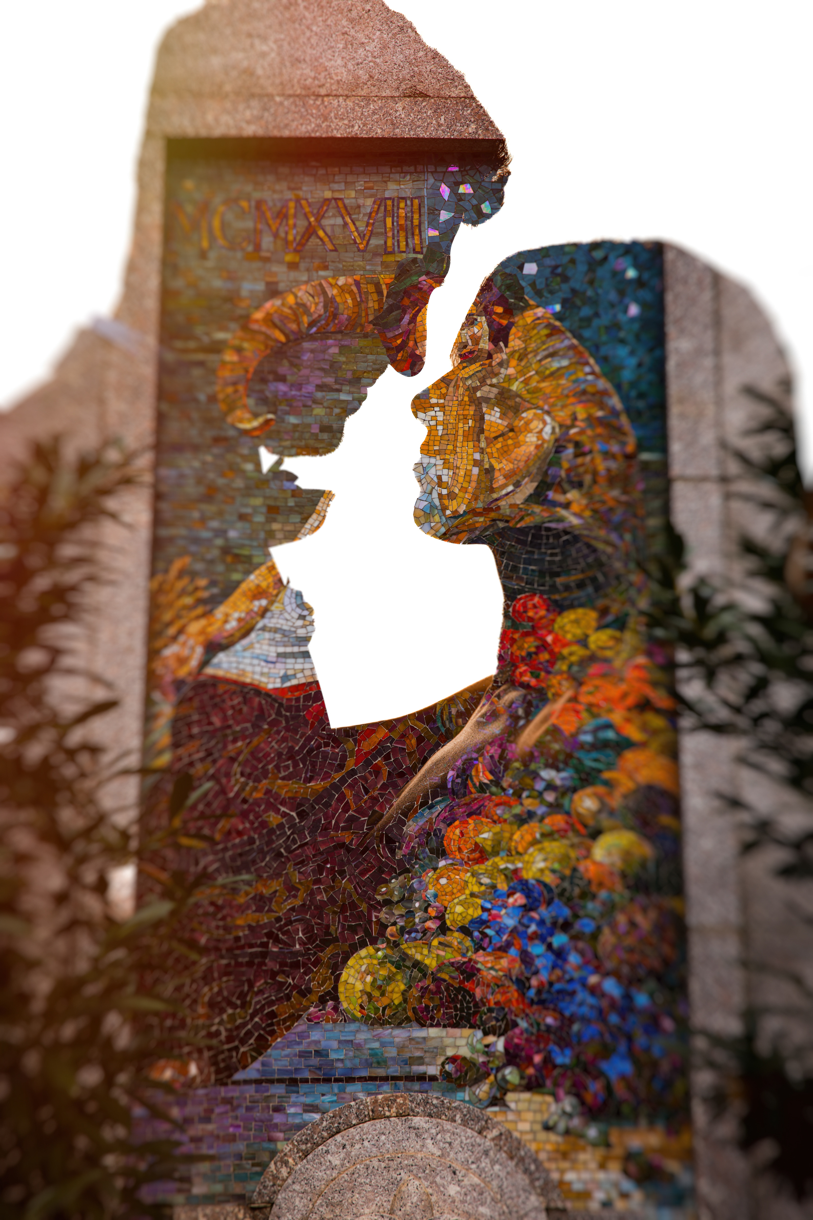 Mosaic artwork of two figures about to kiss, with vibrant colors and floral elements, set against a stone backdrop reminiscent of Guastavino’s wedding architecture. The top shows Roman numerals CMXVIII. Some foliage is visible in the foreground.